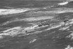 Crew of dismasted yacht waits to be rescued.